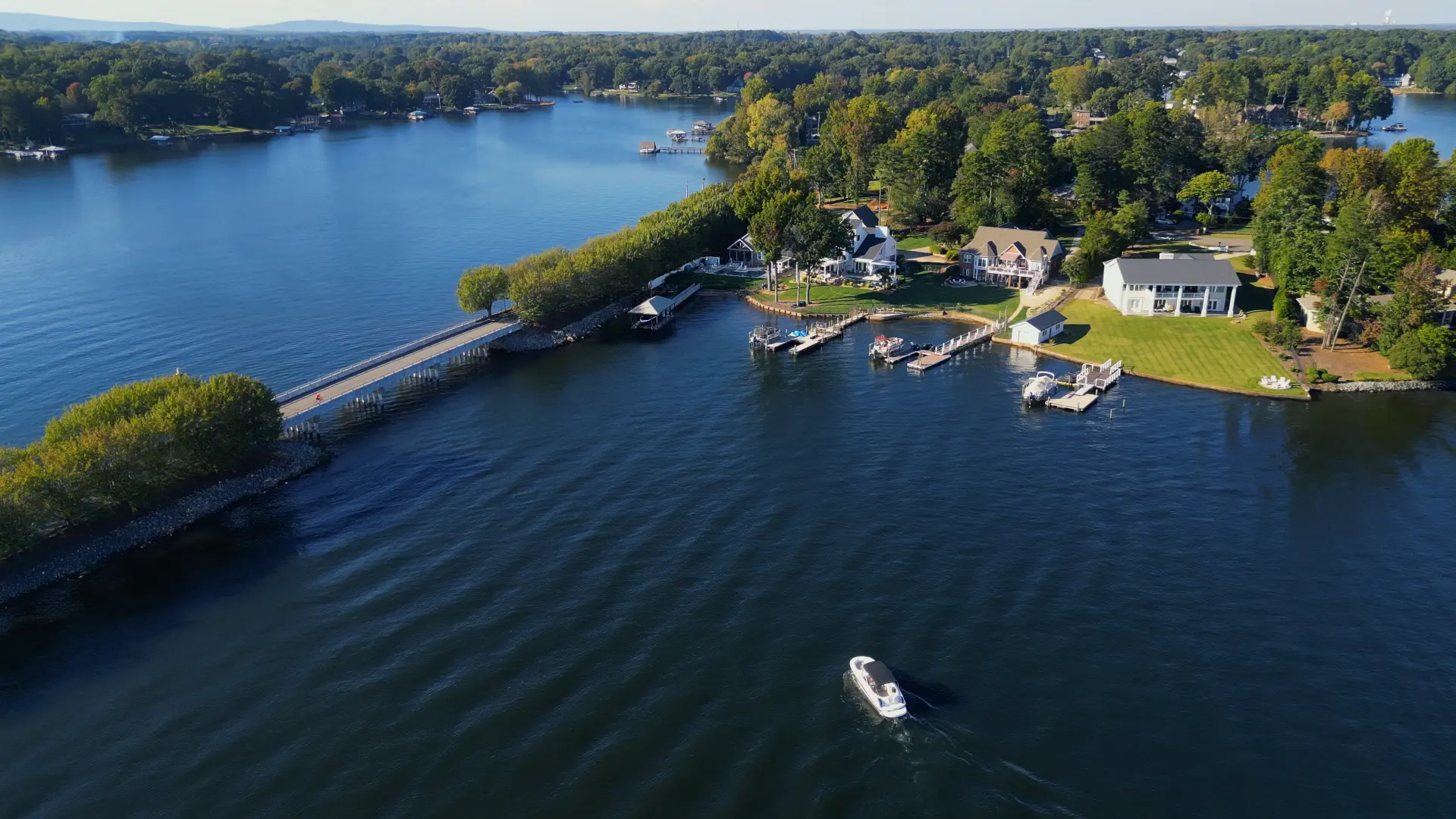 A boat passing waterfront homes on Lake Norman
